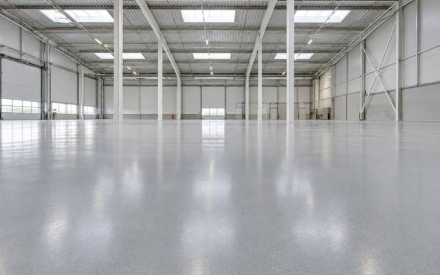 Open warehouse floor with a light grey epoxy coating in Clarington